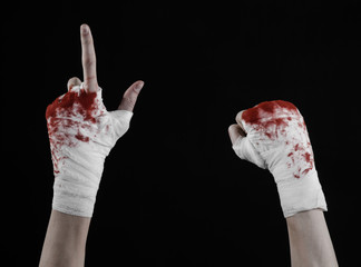 bloody hand in a bandage, bloody bandage, black background © Alex