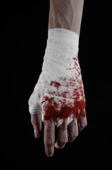 bloody hand in a bandage, bloody bandage, black background