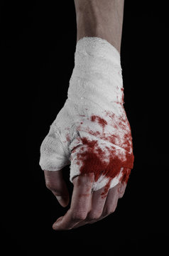 bloody hand in a bandage, bloody bandage, black background