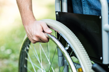 Hand on the wheel of a wheelchair