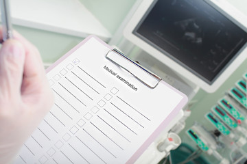 Hospital work. Doctor with a clipboard fills out form of medical