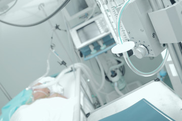 Patient receiving mechanical ventilation in a hospital ward