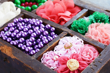 Collection of  brooches, beads and hair pins in wooden box