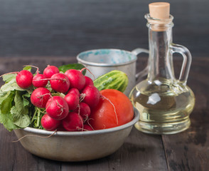 Fresh radishes, tomatoes, cucumbers and olive oil