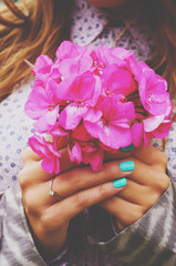 Stylish lady holding bunch of pink flowers in her hands with tea - 83513527