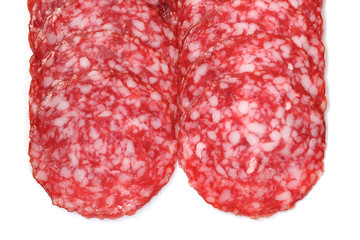 sliced salami on a white.