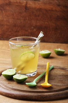 cold gold soft drink from lime and honey with gold straw
