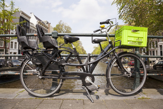 transport bike for children and groceries on bridge in amsterdam