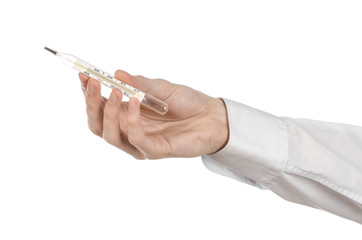 doctor's hand holding a thermometer to measure the temperature