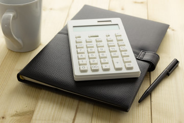 Calculator and Notebook on Desk