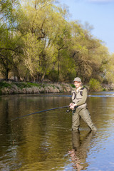 Fototapeta premium woman fishing in the river in spring