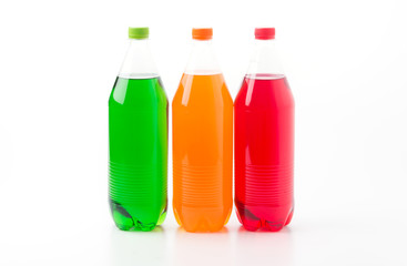 Fototapeta na wymiar Bottles with soft drinks, isolated on a white background