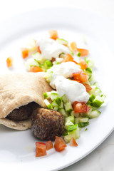 meatball in pan pita with tomato and cucumber salad