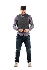 Fototapeta premium Bearded fashionable young man buttoning vest