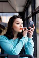 girl brings herself up, looks in the mirror, adjusts makeup