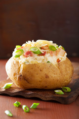 baked potato in jacket with bacon and cheese