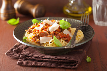 italian pasta spaghetti bolognese with basil on rustic table