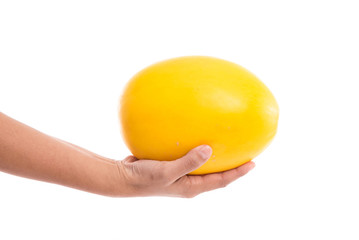 Female's hand holding honeydew melon
