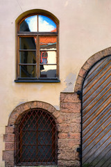 Window with reflection and old gate in the old town