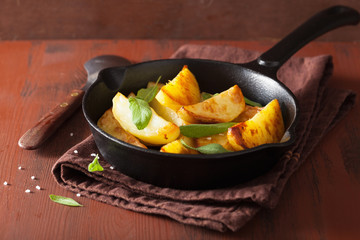 baked potato wedges in black frying pan