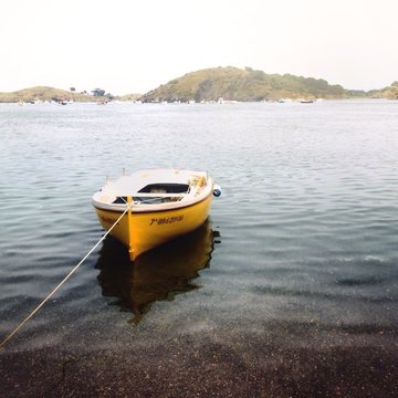 Spain, Cadaques, Boat anchored in calm water
