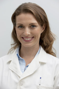 Portrait of a smiling female pharmacist in a laboratory coat