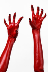Fototapeta premium Red Devil's hands, red hands of Satan, white background isolated