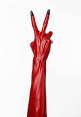 Red Devil's hands, red hands of Satan, white background isolated