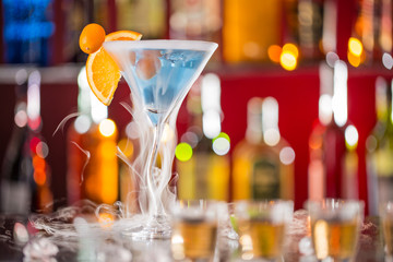 Cocktail with ice vapor on bar desk
