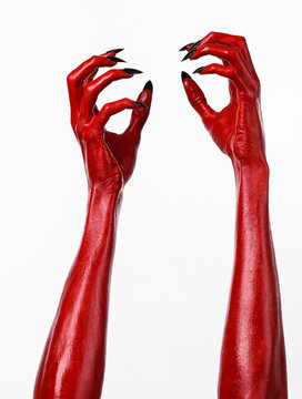 Red Devil's hands, red hands of Satan, white background isolated