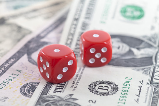 Close-up of two red Dice On US Dollar banknotes
