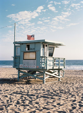 Lifeguard hut with an american flag on a beach in summer, California, USA