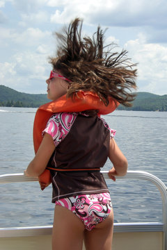 USA, New York State, Adirondack Mountains, rear view of girl (12-13) on boat