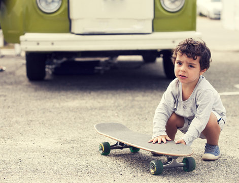 Child with skateboard and van
