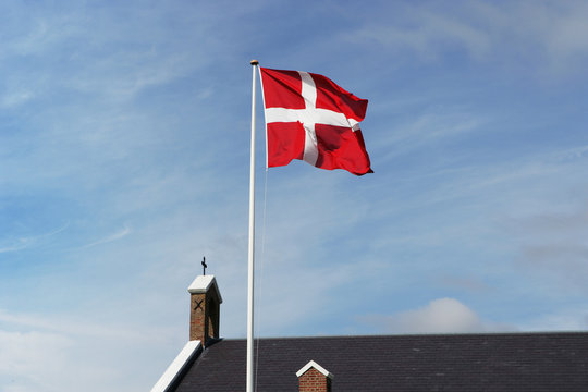 Denmark, Sonderho, Danish flag and church against sky