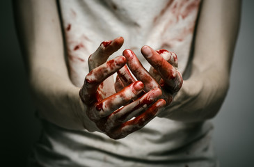 murderer shows bloody hands and experiencing depression and pain - obrazy, fototapety, plakaty
