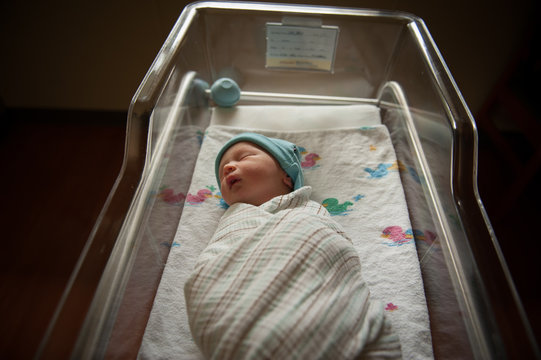 Newborn Baby Sleeping In Hospital Crib