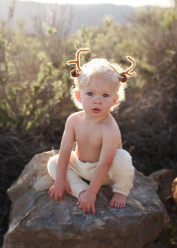 Toddler with antlers on his head