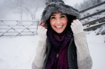 Woman wearing knitwear enjoying snow