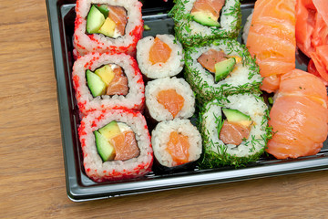 delicious rolls and sushi on a cutting board close-up