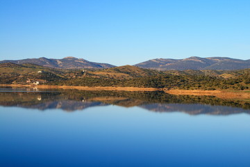 Fototapeta na wymiar Sky reflected in the lake formed by Montoro dam