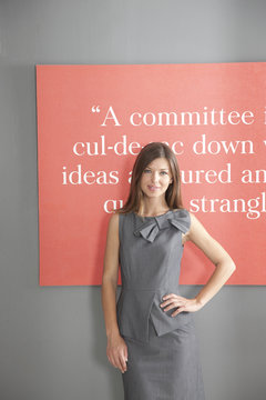 Portrait of businesswoman in front of inspirational quote