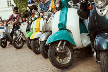 Row of mopeds on a street 