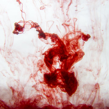 Red ink into water, studio shot