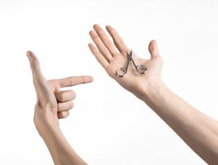 Hand holding scissors for manicure isolated on white background