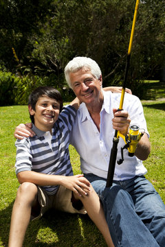 Grandfather and grandson with fishing rod