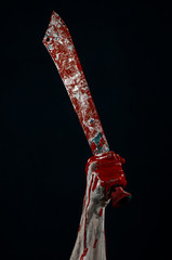 bloody hands holding a bloody machete isolated in studio - obrazy, fototapety, plakaty