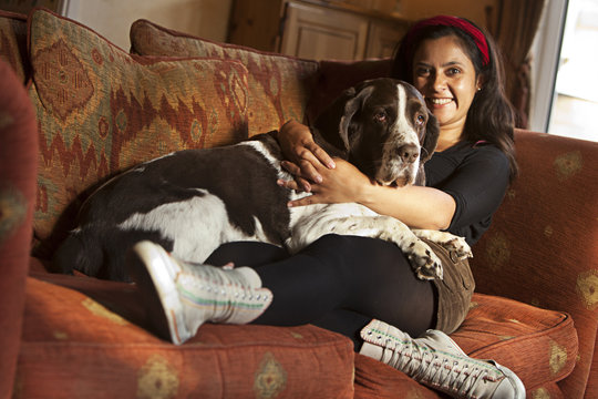 Girl cuddling old dog