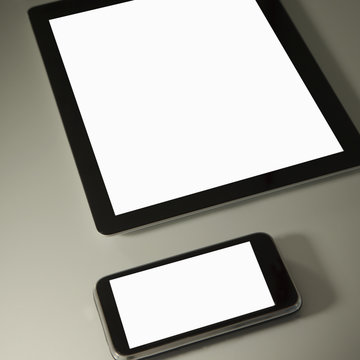 Close-up of a blank digital Tablet and smart phone on a desk in an office