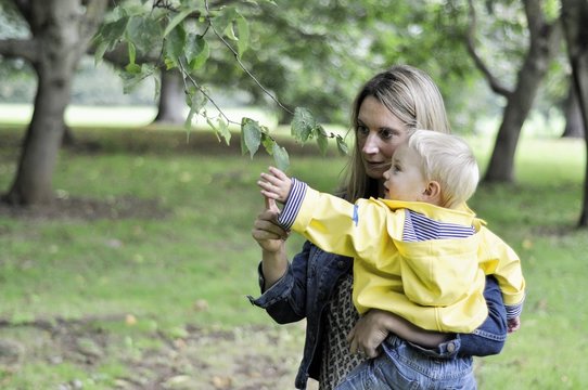 Mother and son looking at leaf